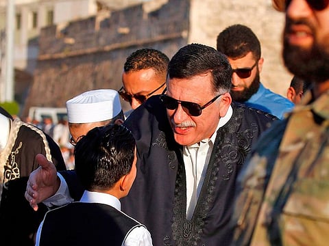 Prime Minister of the Government of National Accord (GNA) of Libya Fayez Al Sarraj greets a boy before performing Eid Al Fitr prayers at the Martyrs Square of the capital Tripoli on June 4, 2019.