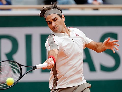 Switzerland's Roger Federer plays a forehand return to Spain's Rafael Nadal during their men's singles semi-final match on day 13 of The Roland Garros 2019 French Open tennis tournament in Paris on June 7, 2019.