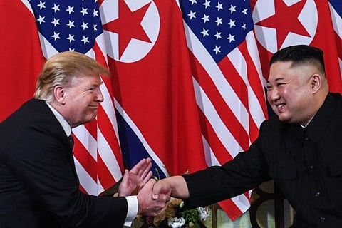 US President Donald Trump shakes hands with North Korea's leader Kim Jong-un following a meeting.