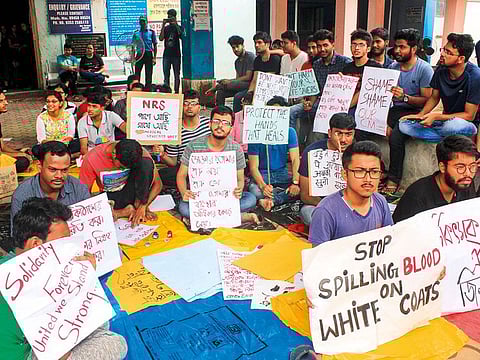 Indian junior doctors hold placards during a protest at North Medical College and Hospital in Siliguri.