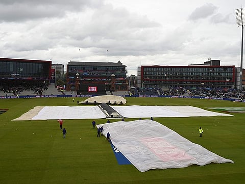 The covers and floodlights are on as rain stops play during the 2019 Cricket World Cup group stage match between India and Pakistan at Old Trafford in Manchester, north-west England, on June 16, 2019.