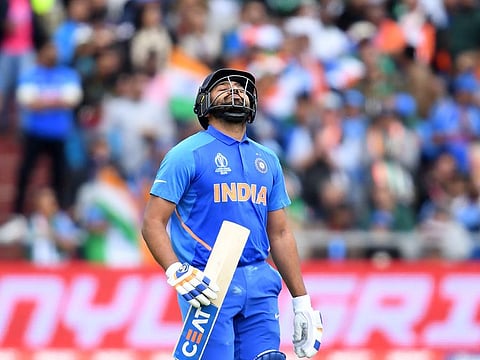 India's Rohit Sharma walks back to the pavilion after his dismissal.
