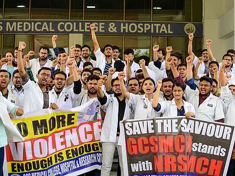 Indian students and doctors of GCS Medical College, Hospital and Research Centre, hold posters and shout slogans as they stage a protest during the nationwide doctors strike held after the recent assault in Kolkata on an intern doctor, in Ahmedabad.
