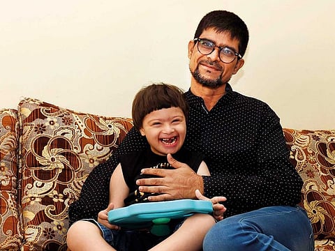 Mohammad Siddiq with his son Ebrahim at their home in Sharjah. Born with Down syndrome, Ebrahim was diagnosed with acute myeloid leukaemia in June last year.