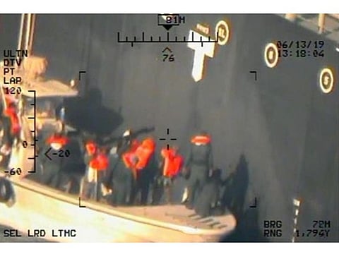 A U.S. military image released by the Pentagon in Washington on June 17, which is says was taken from a U.S. Navy MH-60R helicopter in the Gulf of Oman in waters between Gulf Arab states and Iran on June 13, shows personnel that the Pentagon says are members of the Islamic Revolutionary Guard Corps Navy removing an unexploded limpet mine from the M/T Kokuka Courageous, a Japanese owned commercial motor tanker.
