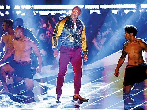 Dwayne Johnson, also known as The Rock, center, accepts the generation award at the MTV Movie and TV Awards