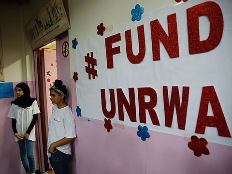 Palestinian refugee students stand outside a classroom as they wait to attend a ceremony to mark the return to school of a new year at one of the UNRWA schools, in Beirut, Lebanon.