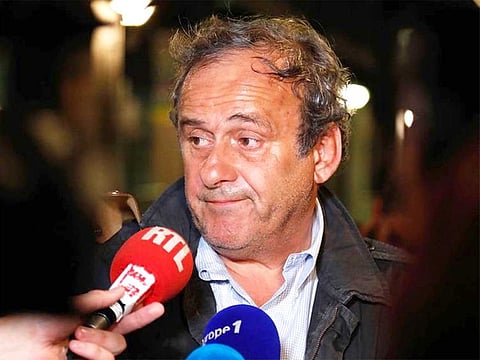 Ex-UEFA chief Michel Platini talks to the media before leaving the Central Office for Combating Corruption and Financial and Tax Crimes after being arrested in connection with a criminal investigation into the award of the 2022 World Cup to Qatar, in Nanterre, west of Paris in the early hours of June 19, 2019.