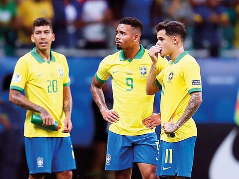 Brazil's Gabriel Jesus, centre, waits for the referee to decide on the validity of his goal with teammates Roberto Firmino, left, and Philippe Coutinho, right, during a Copa America Group A soccer match at the Arena Fonte Nova in Salvador, Brazil, Tuesday, June 18, 2019.