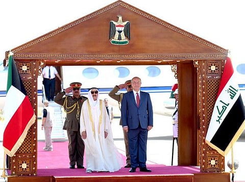 A handout picture released by the media office of the Iraqi Presidency shows President Braham Saleh (right) welcoming Kuwait's Emir Shaikh Sabah Al Ahmed Al Sabah in Baghdad on June 19.