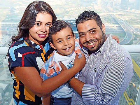 Aya Baker, her husband Tarek Ahmad Fouad Syed and son Yousuf at their home in Dubai. Tarek and Aya are grateful that their first son Yousuf is unaffected by their genetic condition.