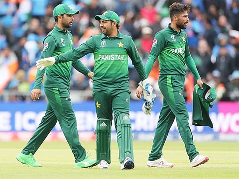 Pakistan's captain Sarfaraz Ahmad, centre, and teammates leave at the end of India's innings during their World Cup match at Old Trafford in Manchester, on June 16, 2019.