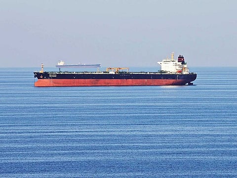 An oil tanker passes through the Strait of Hormuz. Companies are charging at least $180,000 in premiums to go to the Arabian Gulf.