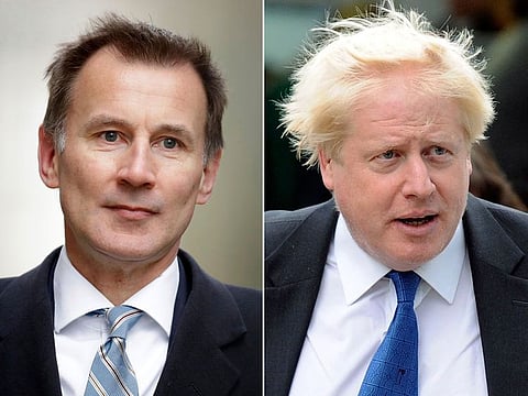 In this two photo file combo image, Jeremy Hunt, left, and Boris Johnson, right, who are the final two contenders for leadership of the Conservative Party, Thursday June 20, 2019.