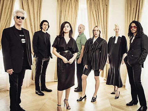 From left: The writer-director Jim Jarmusch with his “The Dead Don’t Die” cast, including Adam Driver, Selena Gomez, Bill Murray, Chloë Sevigny, Tilda Swinton and Luka Sabbat, in Cannes, France, May 14, 2019. To make the dark, zombie comedy, Jarmusch wrote letters to actors he had grown to trust.