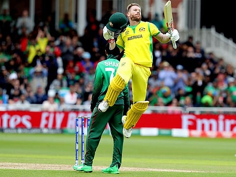 Australia's David Warner leaps in the air to celebrate scoring a century during the World Cup match against Bangladesh at Trent Bridge in Nottingham, on June 20, 2019.