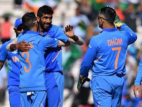 India's Jasprit Bumrah (C) celebrates with teammates after the dismissal of Afghanistan's Hashmatullah Shahidi during the match at the Rose Bowl in Southampton.