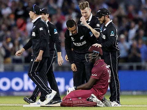 West Indies' Carlos Brathwaite (centre) is consoled by New Zealand players having fallen short in the run-chase during their match at Old Trafford in Manchester, on June 22, 2019.