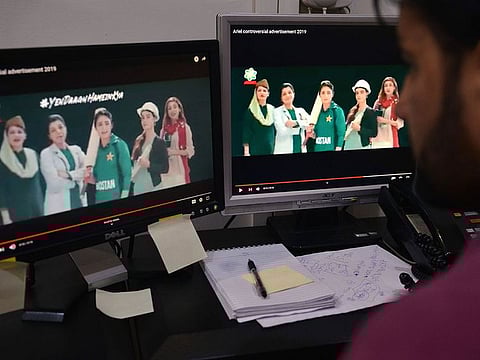 A Pakistani man watches a television commercial of a detergent in which takes part Pakistan women’s cricket team captain Bismah Maroof.