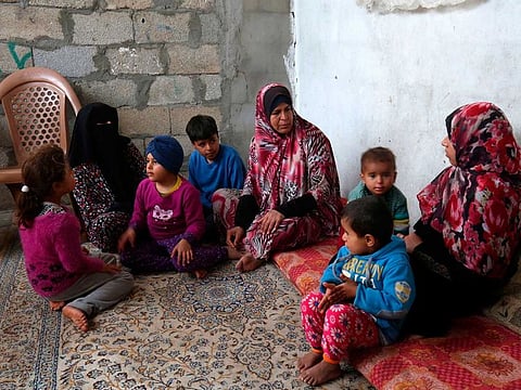 Angham Zorab (left) sits with family members at their home in the southern Gaza Strip refugee camp of Khan Younis on February 26, 2019. Angham Zorab's two brothers along with her husband fled the blockaded Palestinian enclave in June 2014 -- like many others who see no hope in remaining.