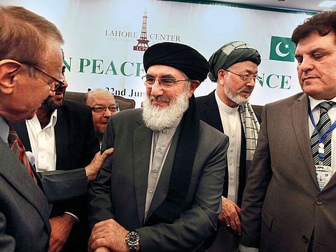 Gulbuddin Hekmatyar (centre), leader of Hezb-e-Islami, with participants after the opening session of Afghan Peace Conference in Bhurban.