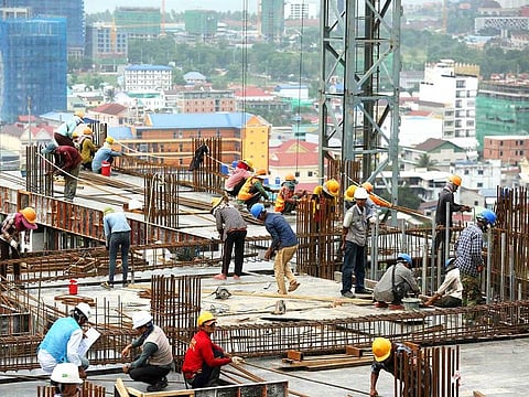 Cambodian labourers work on a high rise building construction site in Sihanoukville.