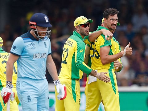 Australia's Mitchell Starc turns and give a thumbs up towards the dressing room after taking the wicket of England's captain Eoin Morgan during their World Cup match at Lord's cricket ground in London.