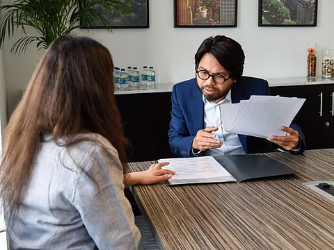Attorney Barney Almazar from Gulf Law with Andrea, who has finally able to settle her Dh 1.7million credit card debt with her bank which ballooned over a decade.