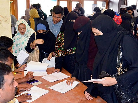 Muslim investors register their complaints against IMA (I Monetary Advisory) jewellery fraud at a temporary police post set up at Shivajinagar, in Bengaluru, Wednesday, June 12, 2019.