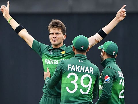 Pakistan's Shaheen Shah Afridi (left) celebrates with teammates after the dismissal of New Zealand's Colin Munro during their World Cup group stage match at Edgbaston in Birmingham, on June 26, 2019.