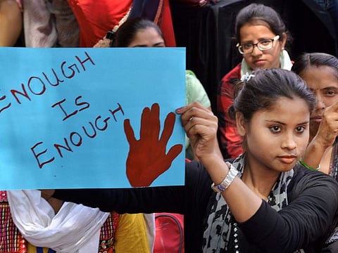 New Delhi: Women and children druing a dharna aganist rape incidents at Rajghat in New Delhi on Friday. PTI Photo (PTI4_13_2018_000116B)