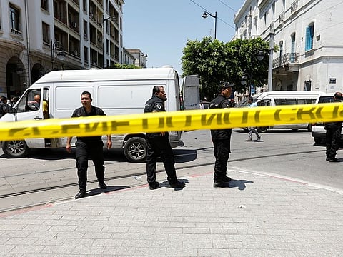 Police officers stand guard at the site of an explosion in downtown Tunis