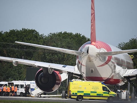 Police surround an Air India passenger jet that was diverted and landed at Stansted airport in Stansted, northeast of London on June 27, 2019.