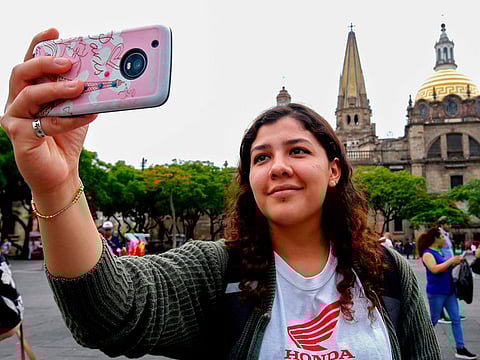 A tourist makes a selfie in front of the Cathedral of Guadalajara, Jalisco state, Mexico, on June 19, 2019.