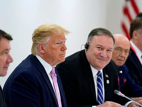 U.S. Secretary of State Mike Pompeo looks next to U.S. President Donald Trump at the G20 summit.