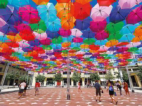Visitors take shelter from the heat under Umbrella Sky Project" installation by Portuguese artist Patricia Cunha in Aix-en-Provence as a heatwave hits France