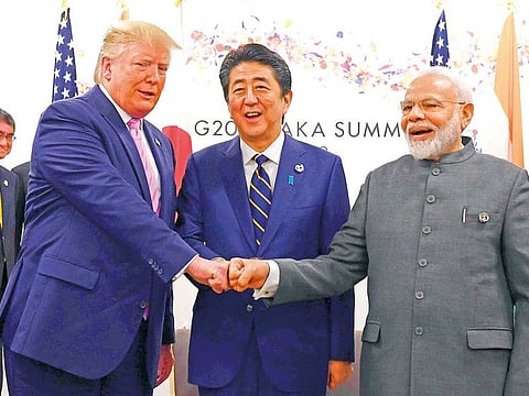 US President Donald Trump, Japan’s Prime Minister Shinzo Abe and India’s Prime Minister Narendra Modi place their fists together at the G-20 summit in Osaka, Japan
