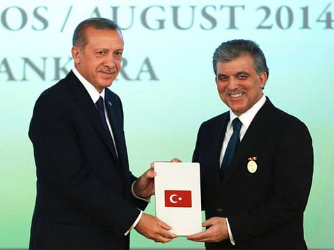 Turkey's new President Tayyip Erdogan (L) and outgoing President Abdullah Gul, attend a handover ceremony at the Presidential Palace of Cankaya in Ankara August 28, 2014.
