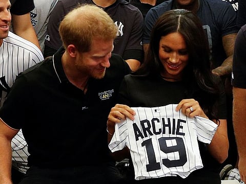 Britain's Prince Harry, Duke of Sussex, and his wife Meghan, Duchess of Sussex react as they are presented with gifts for her newborn son Archie, as they meet New York Yankees players ahead of their match against the Boston Red Sox at the London Stadium in Queen Elizabeth Olympic Park, east London on June 29, 2019, for the first of a two-game Baseball series in London. As Major League Baseball prepares to make history in London, New York Yankees manager Aaron Boone and Boston Red Sox coach Alex Cora are united in their desire to make the ground-breaking trip memorable on and off the field.