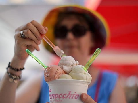 A woman eats ice cream in Nice as a heatwave hits much of the country, France, June 28, 2019.
