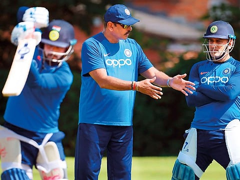 India's Rishabh Pant (L) bats as Mahendra Singh Dhoni (R) and head coach Ravi Shastri (C) look on during a training session at Edgbaston in Birmingham, central England.
