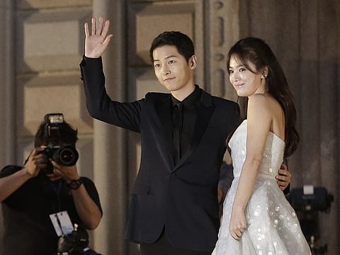 In this June 3, 2016 file photo, South Korean actress Song Hye-kyo, right, and actor Song Joong-ki pose as they arrive for the Baeksang Arts Awards in Seoul, South Korea.