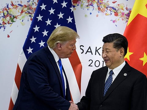 China's President Xi Jinping (R) greets US President Donald Trump before a bilateral meeting on the sidelines of the G20 Summit in Osaka on June 29, 2019.