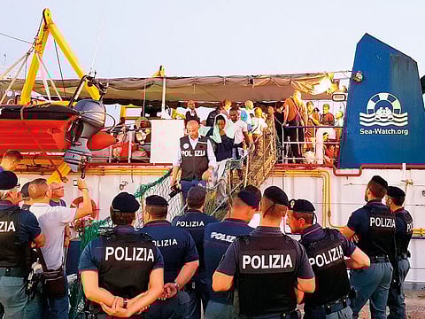 Migrants disembark from the Ducth-flagged Sea-Watch 3 ship, at Lampedusa island's harbor, Italy.