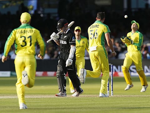 Australia's Mitchell Starc (C) celebrates with teammates after taking the wicket of New Zealand's captain Kane Williamson (2L) during their match at Lord's Cricket Ground in London.