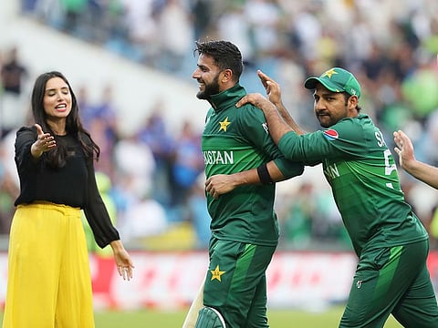 Pakistan's Imad Wasim is congratulated by Pakistan's captain Sarfaraz Ahmad, second right, after their win against Afghanistan at Headingley in Leeds.
