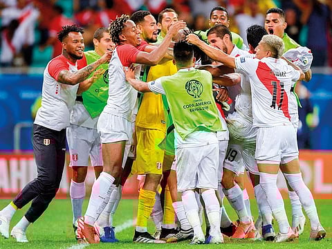 Peru’s players celebrate after defeating Uruguay in the penalty shoot-out after tying 0-0 during their Copa America football tournament quarter-final match at the Fonte Nova Arena in Salvador, Brazil.