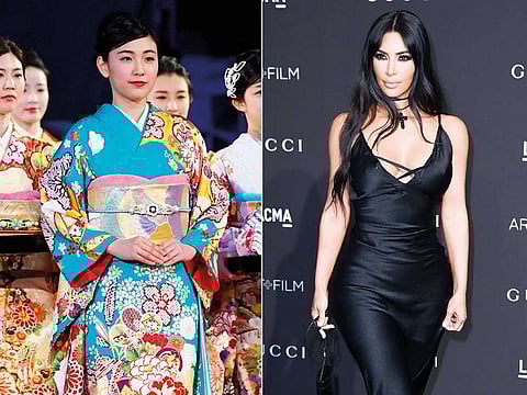 Kim Kardashian West (right) has earned some backlash from Japanese people and others on social media who object to her appropriation of the traditional Japanese kimono as part of the name of her upcoming shapewear line.