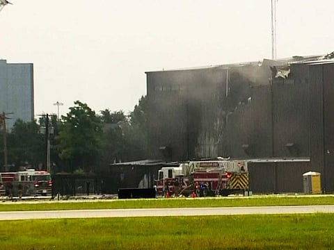 This image made from video provided by WFAA-TV shows responders at a deadly small plane crash at Addison Airport in Addison, Texas, Sunday, June 30, 2019. The small airplane crashed as it was taking off from the Dallas-area airport Sunday morning, a spokeswoman for the town of Addison, Texas, said.