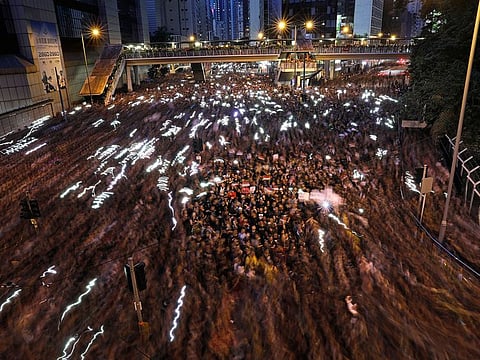 A blur of thousands of protesters march on the streets against an extradition bill in Hong Kong on Sunday, June 16, 2019.
